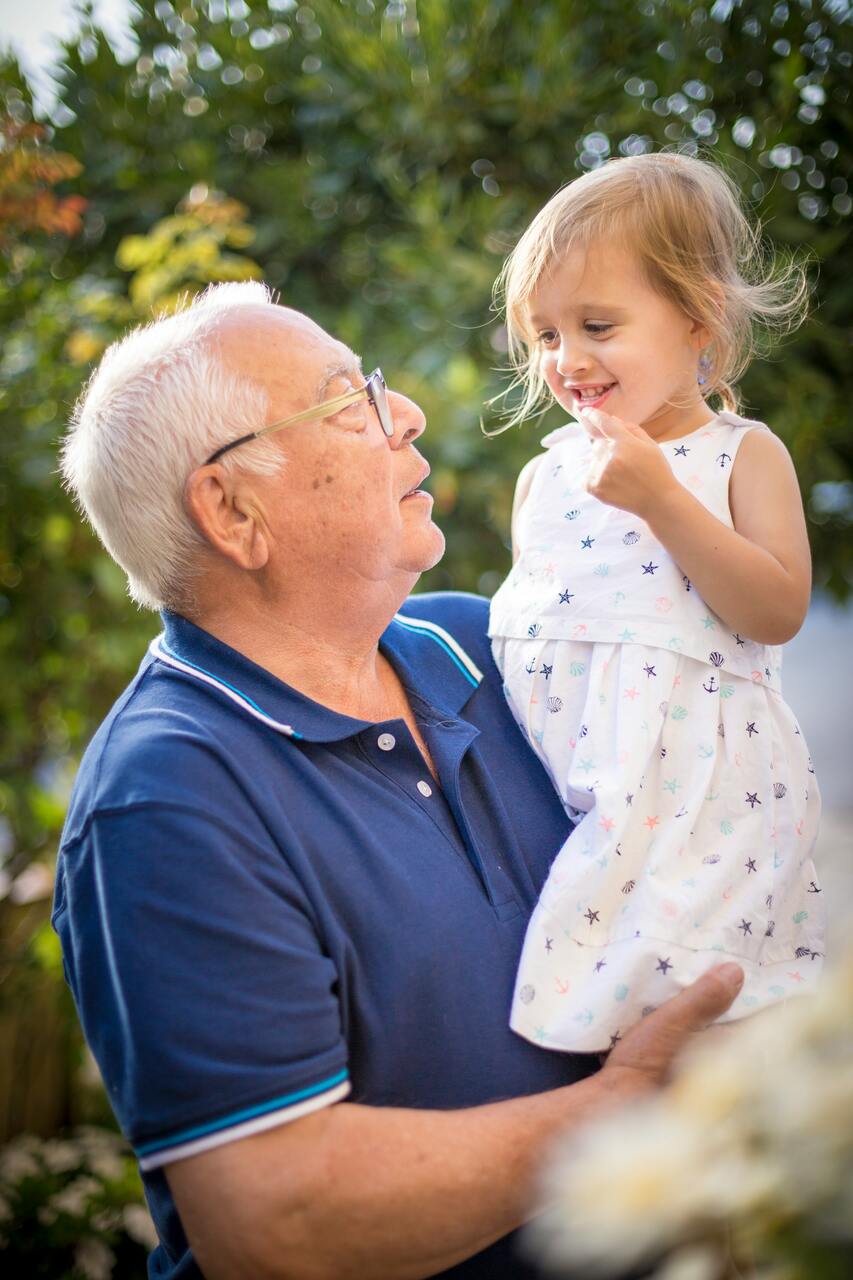 grandfather holding granddaughter image